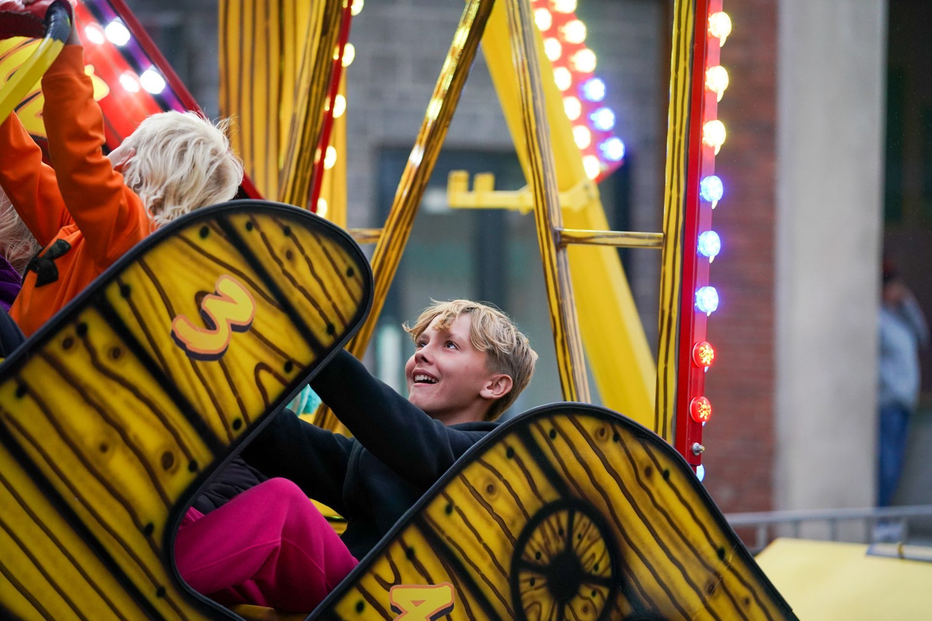 a group of children are riding a carnival ride