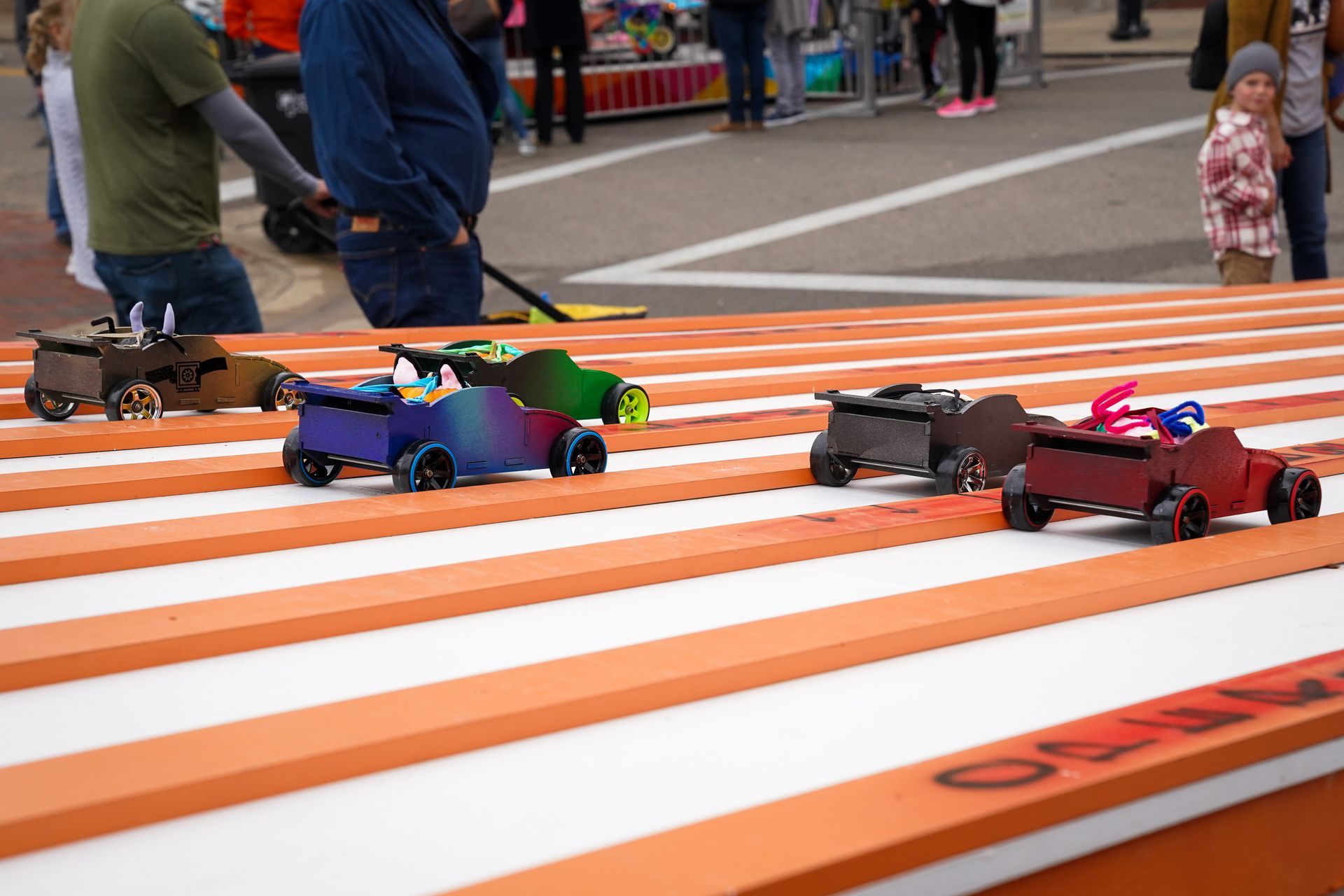 a group of toy cars are racing on a track