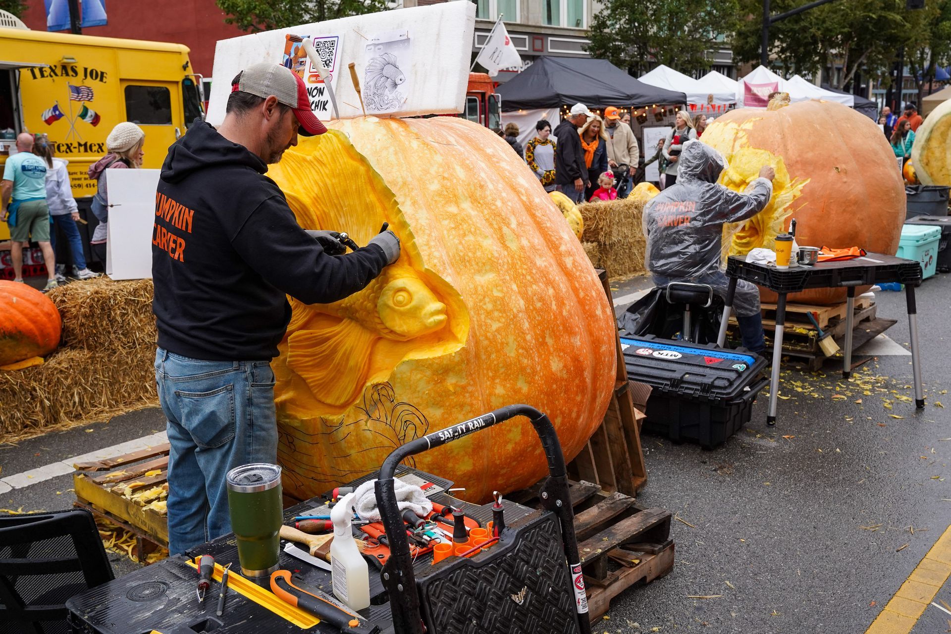 a man carving a pumpkin