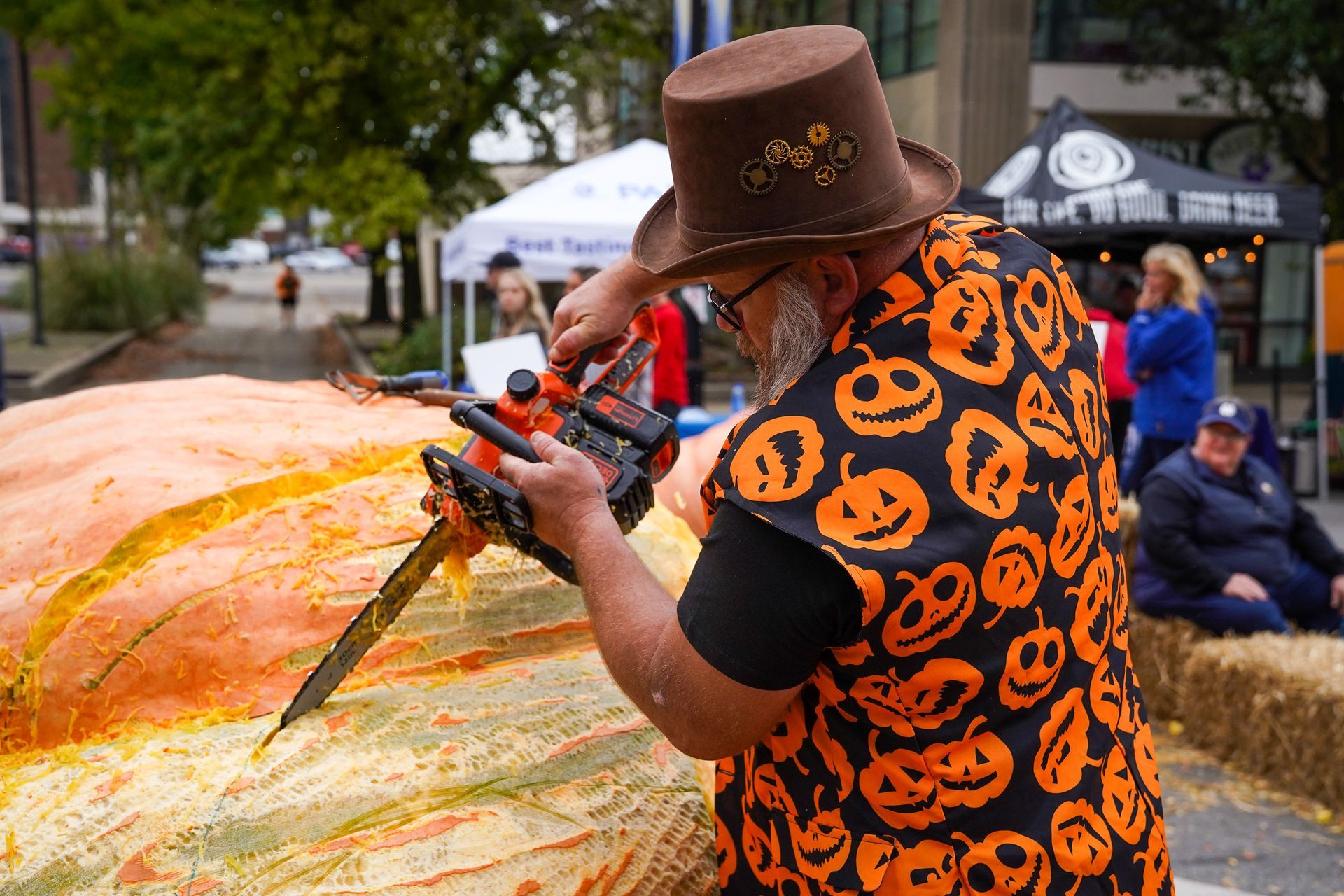 man carving a pumpkin