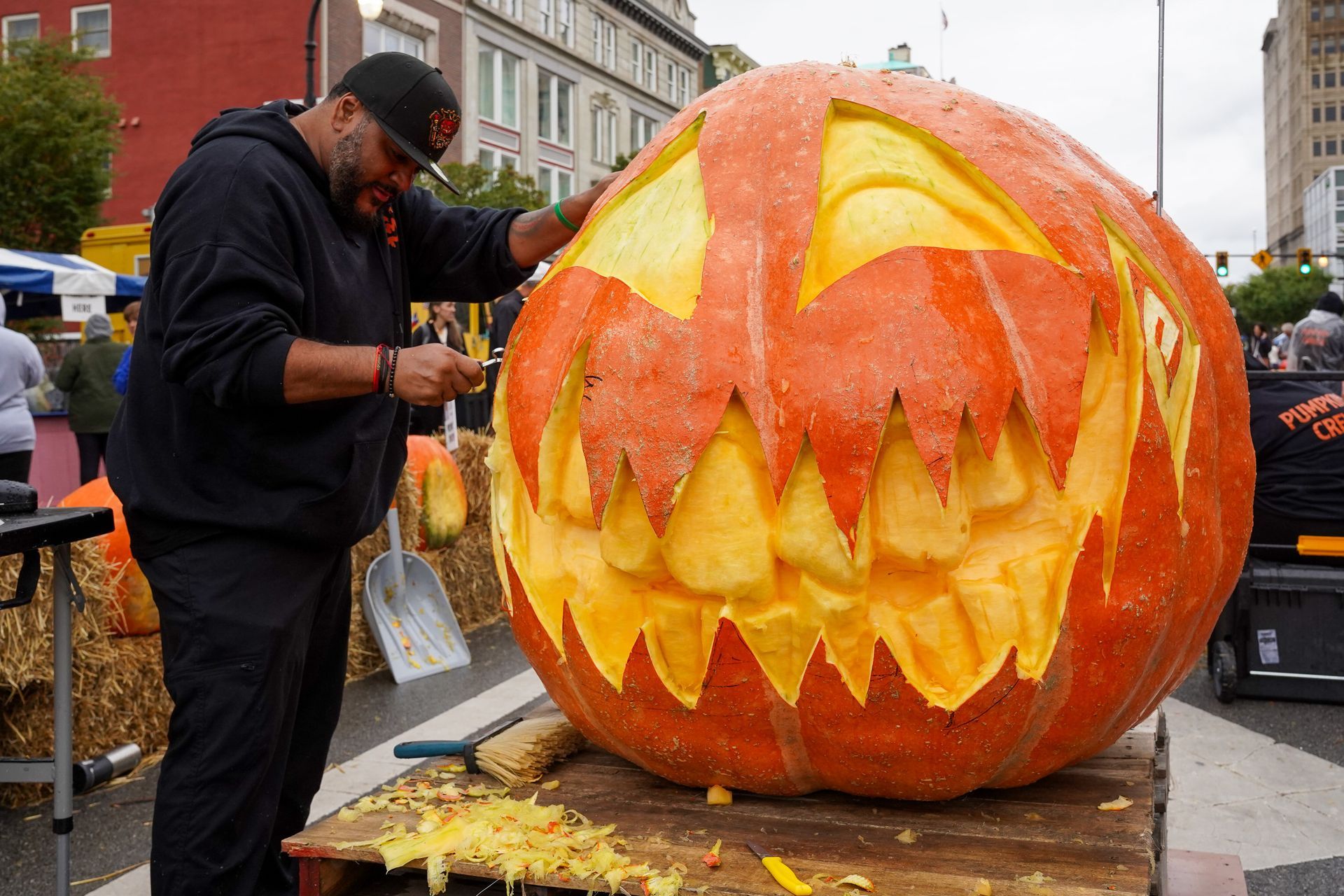 man carving a pumpkin