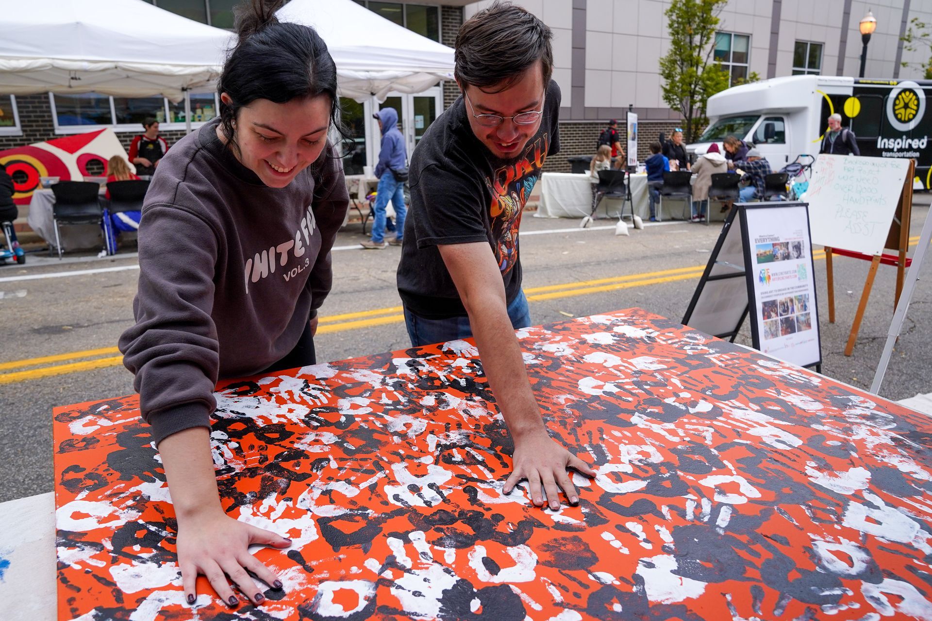 a man and a woman are putting their hands on a table
