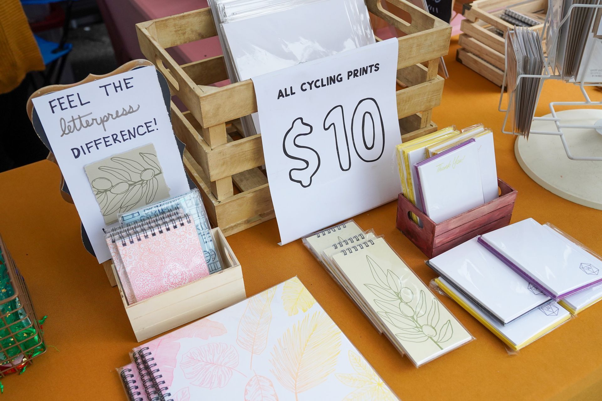 a table with notebooks and a sign that says $ 10