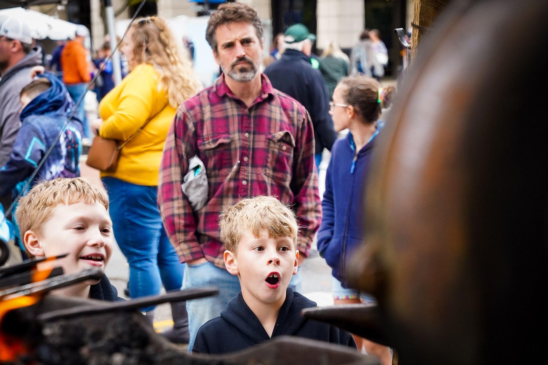 a group of people are standing around a fire