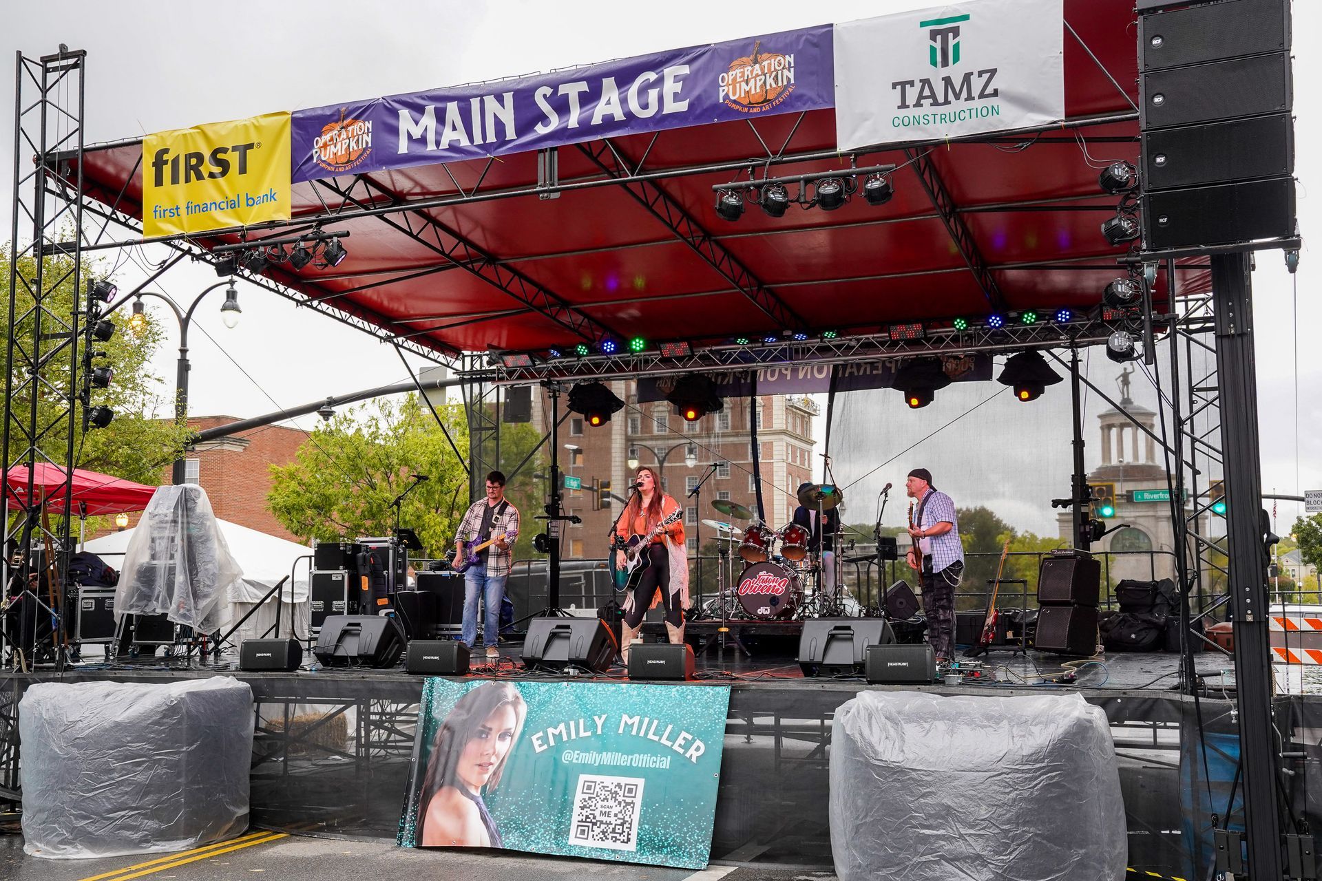 a band is playing on a stage with a sign that says main stage