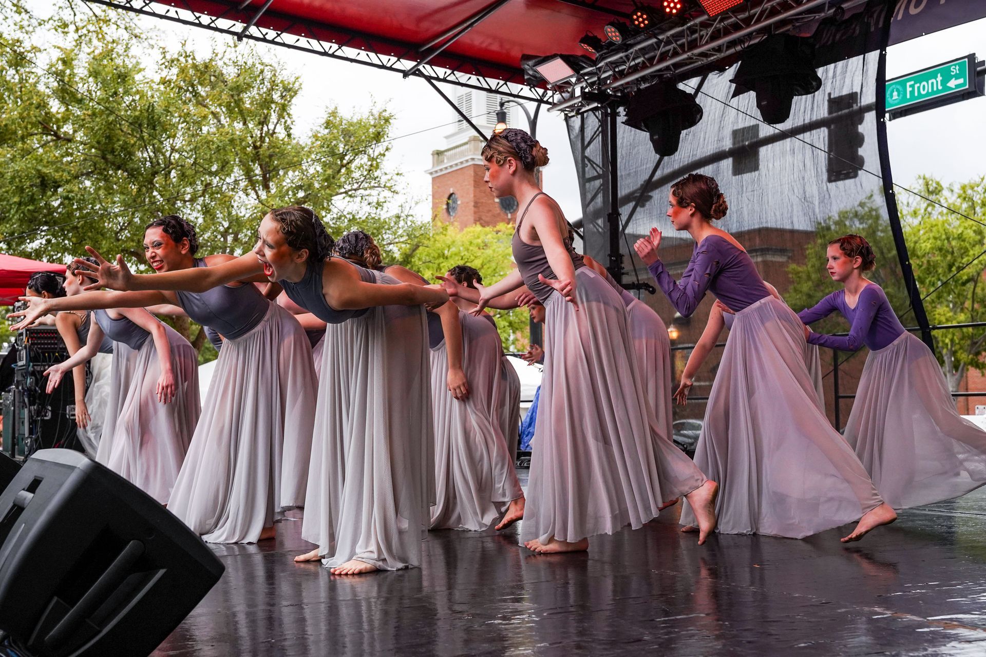 a group of women are dancing on a stage