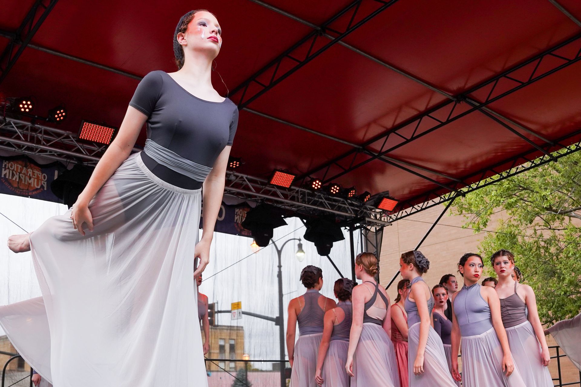 a group of young women are dancing on a stage