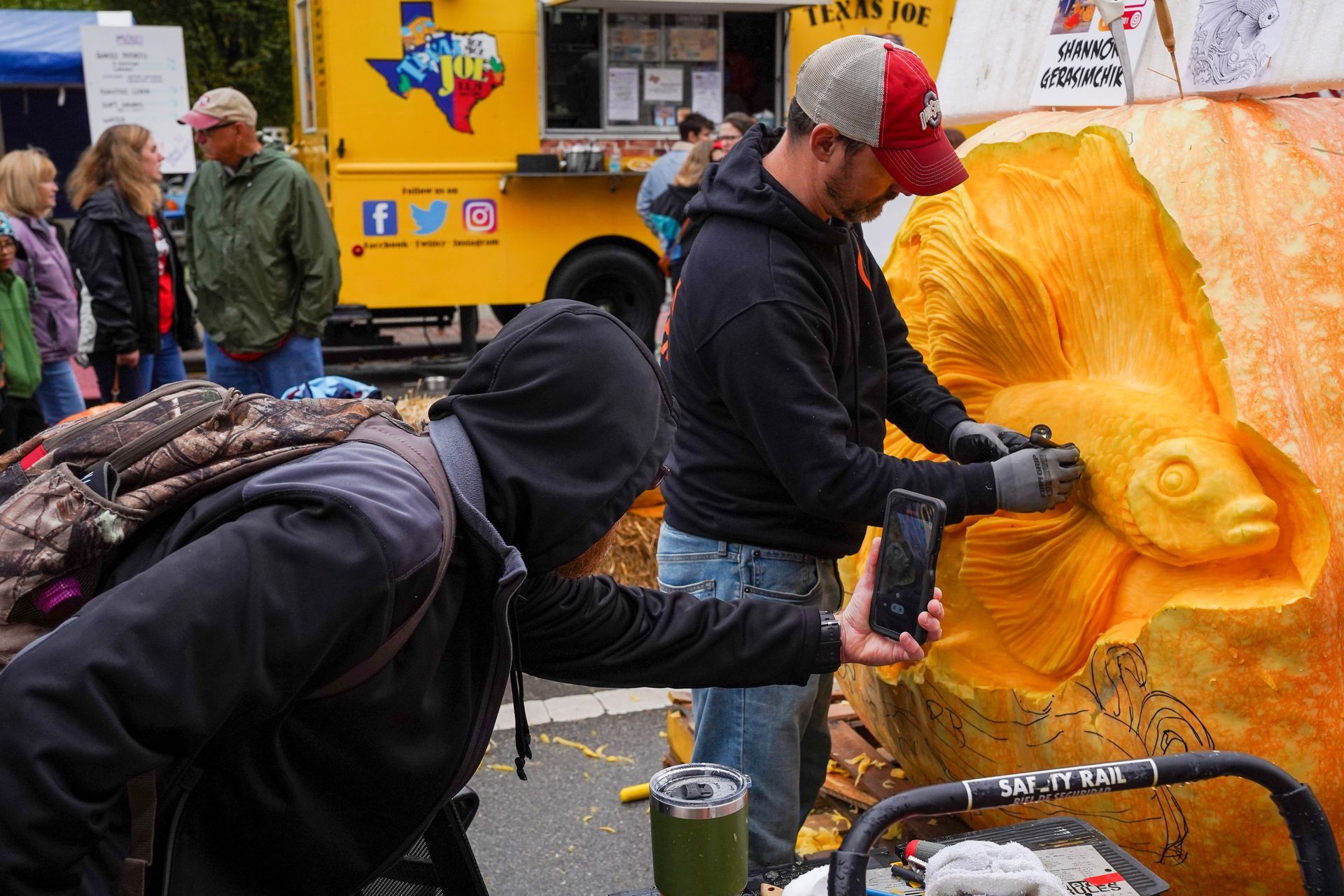 man carving a pumpkin