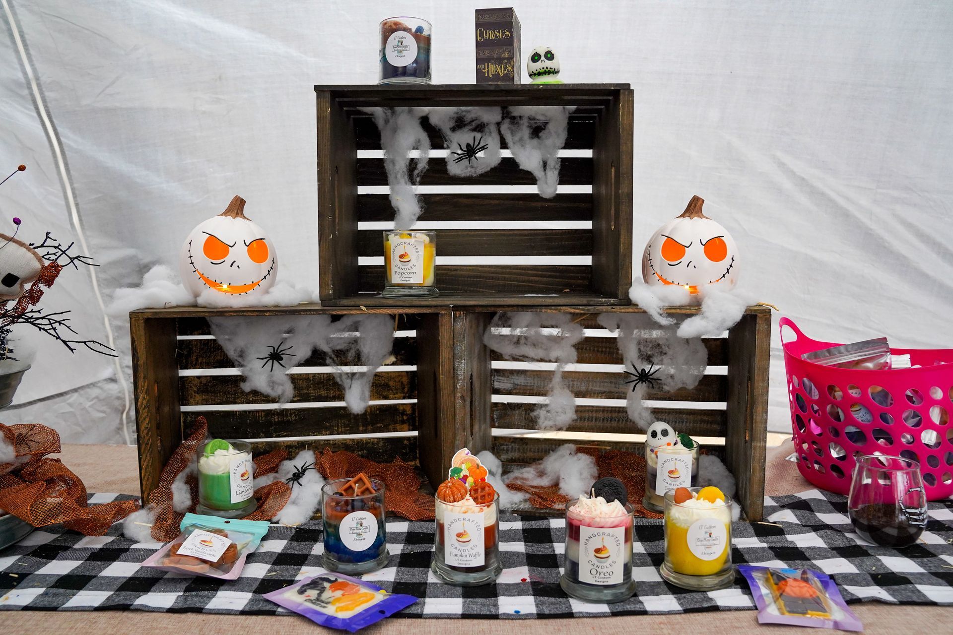 a table decorated for Halloween with pumpkins, ghosts, and candles