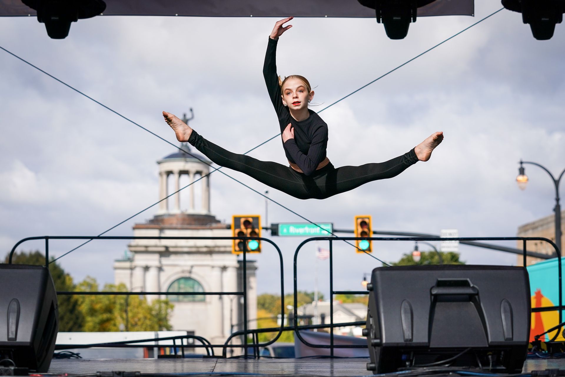 a woman is doing a split in the air on a stage
