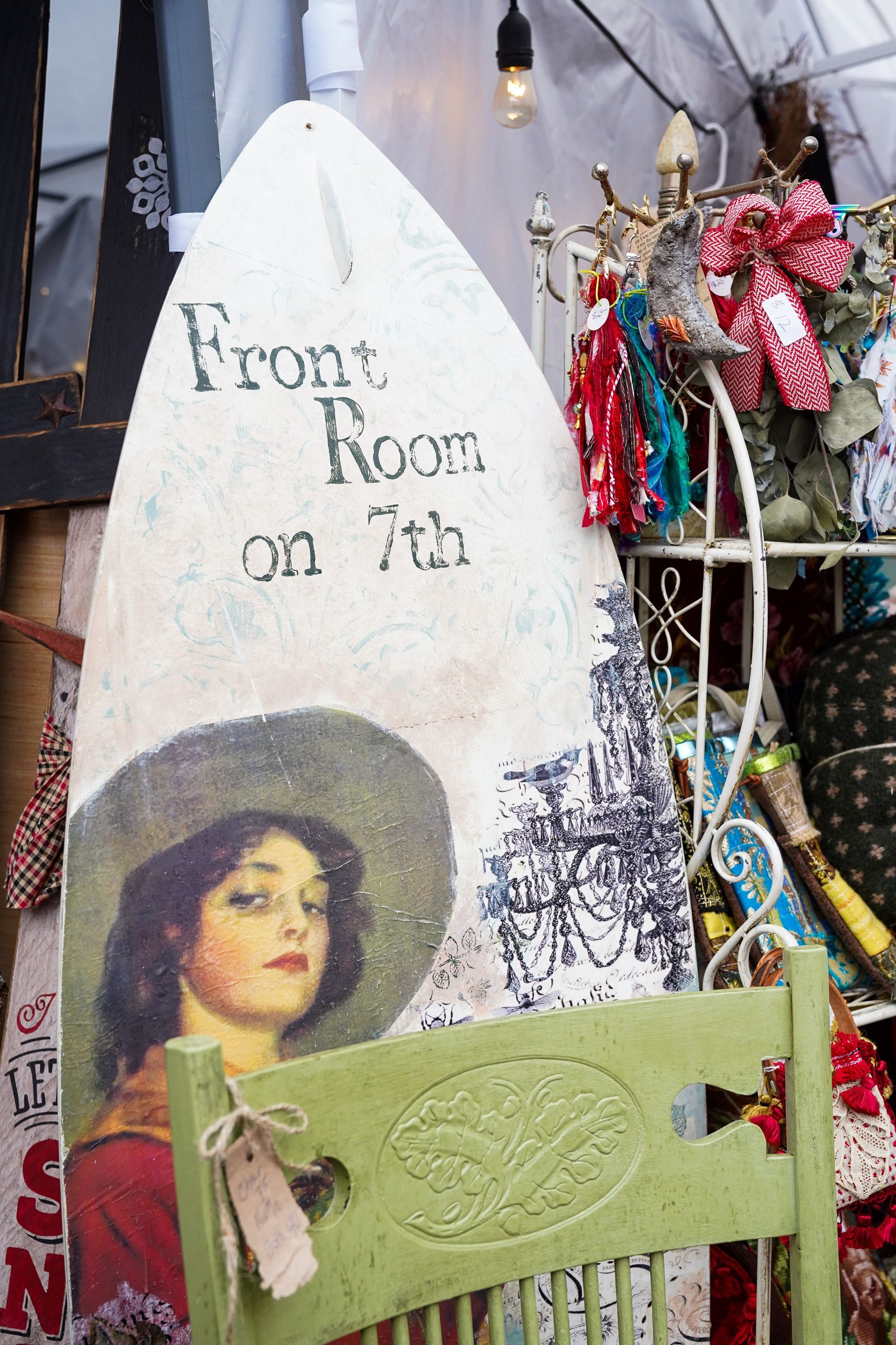 a green chair with a sign on it that says front room on 7th