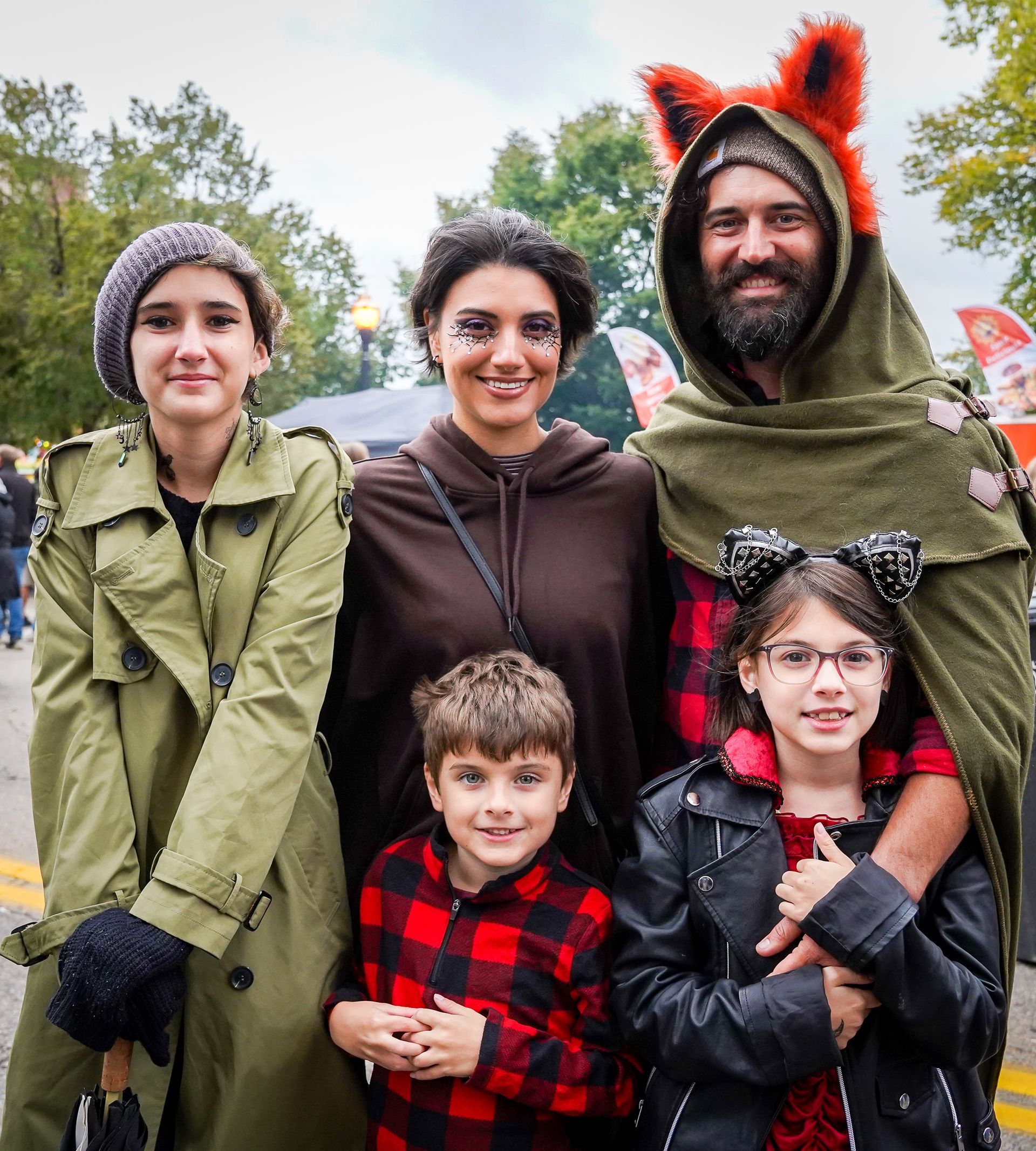 a group of people posing for a picture including a man dressed as a fox