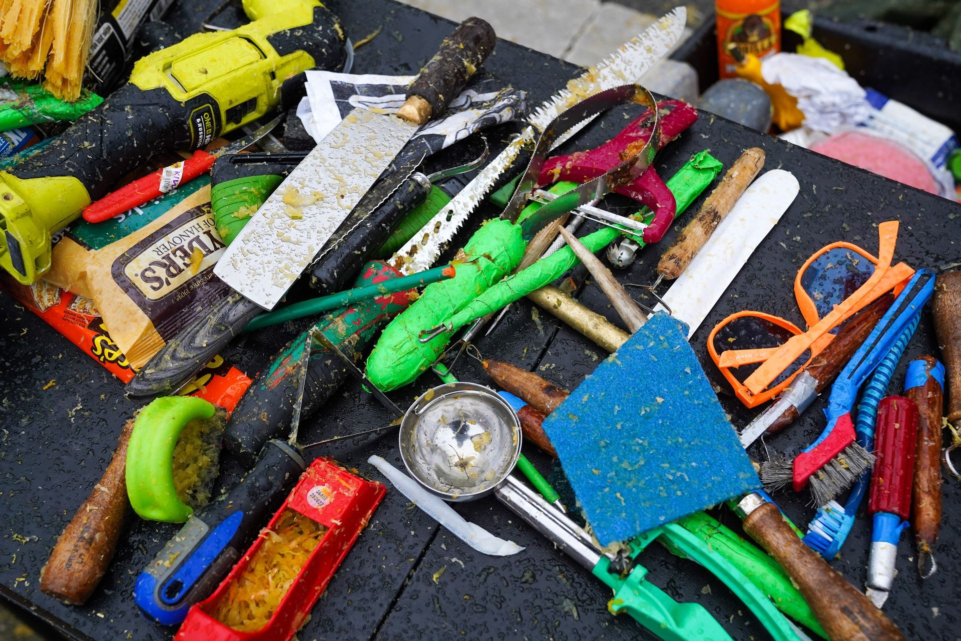 a bunch of tools on a table including a drill