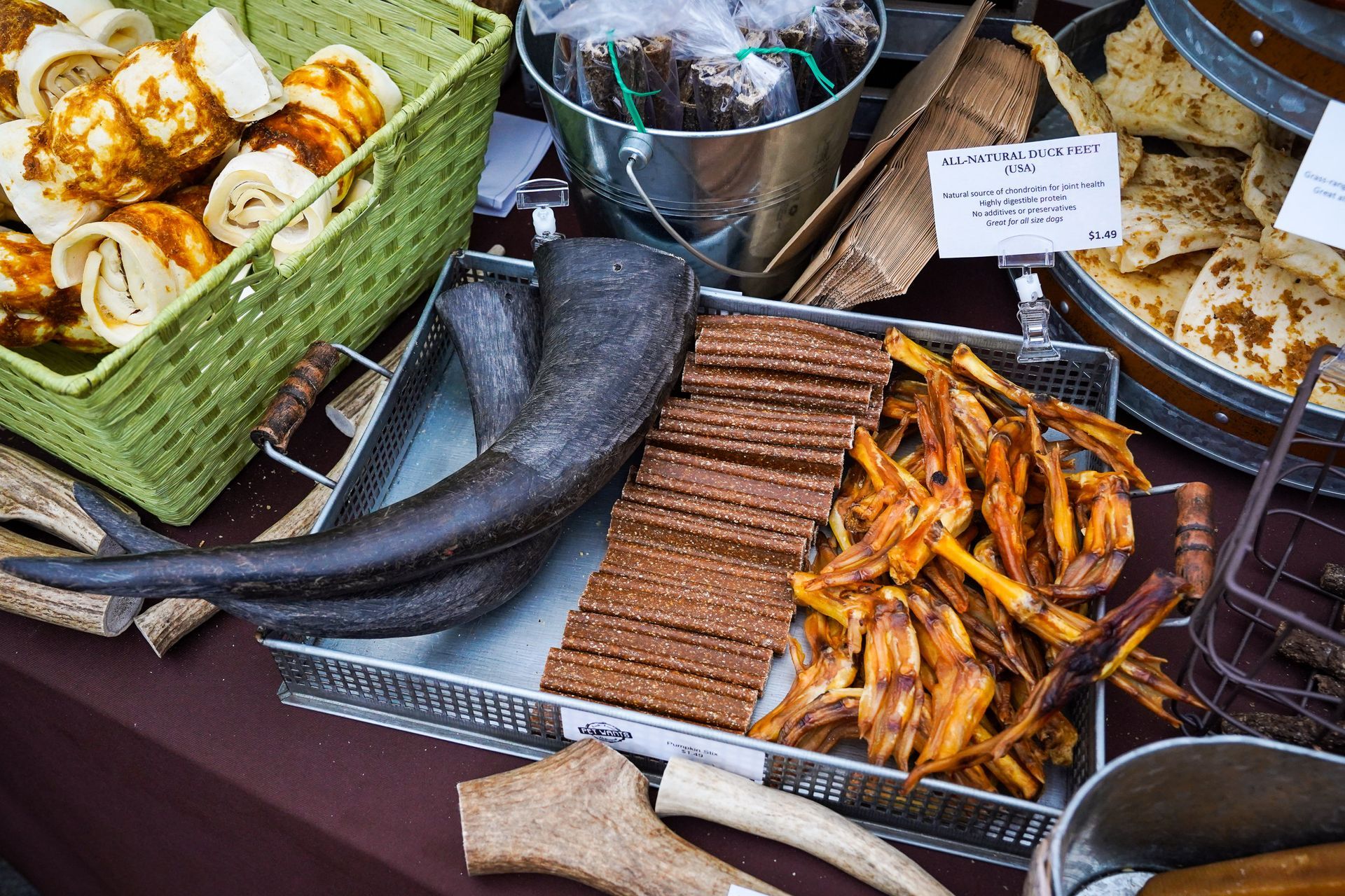 a table topped with a variety of dog treats and horns