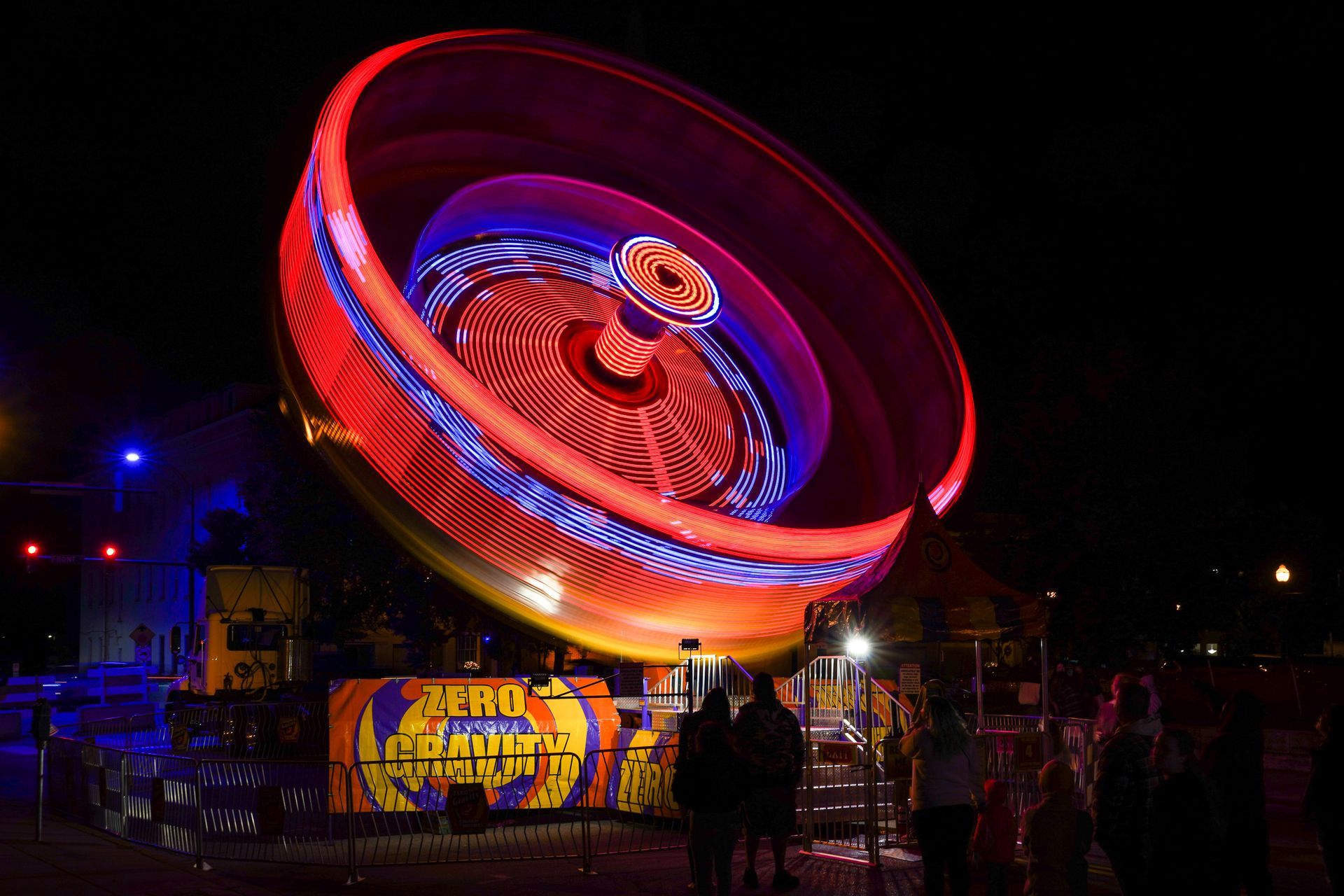 a ferris wheel at a carnival is lit up at night