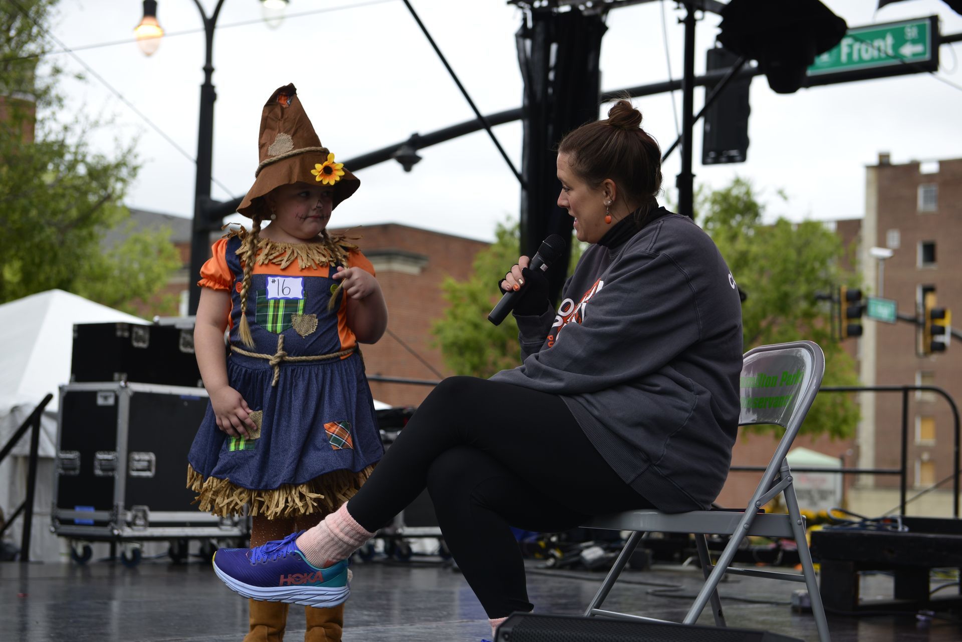 woman interviewing a kid on a stage