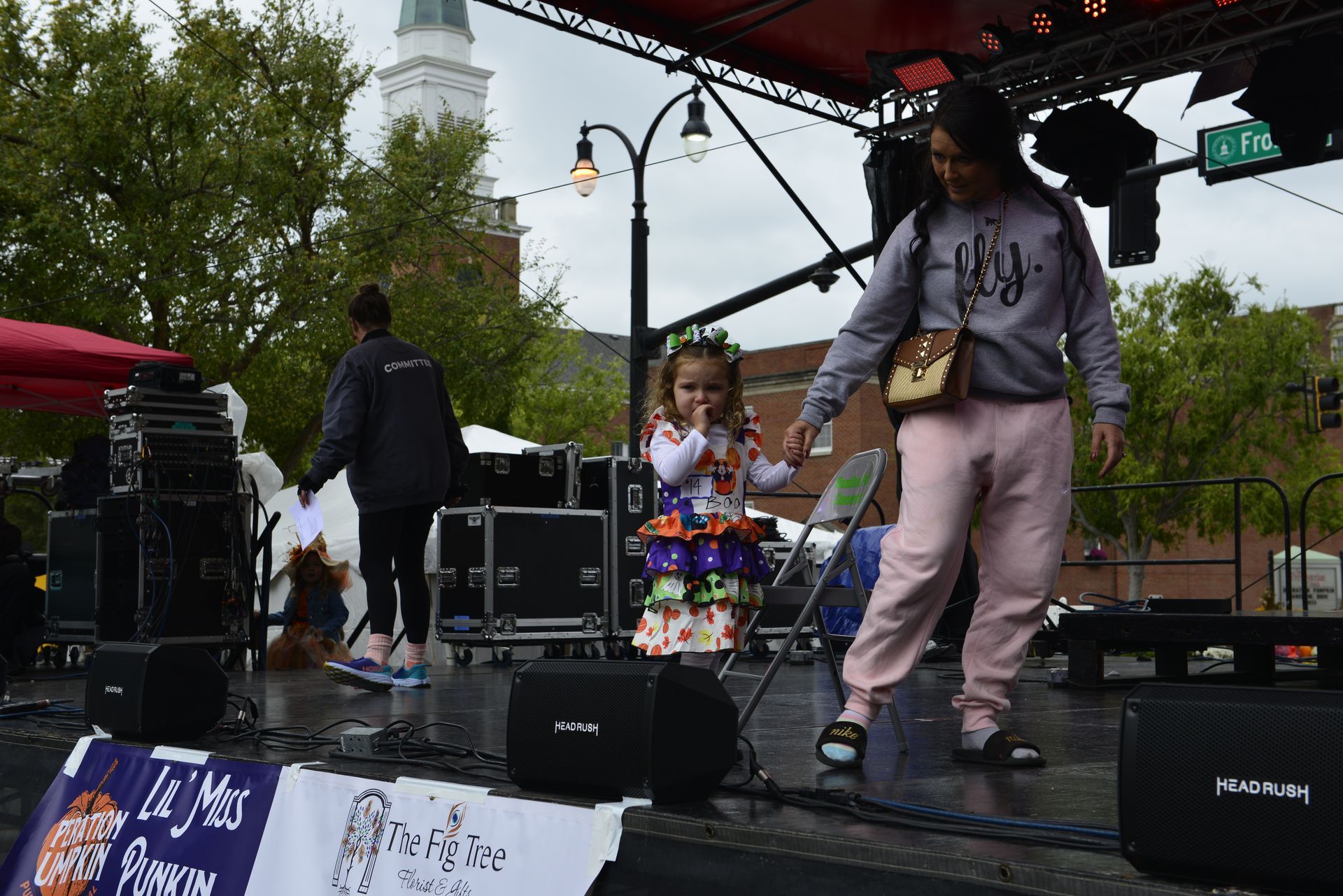 a woman and a little girl are dancing on a stage
