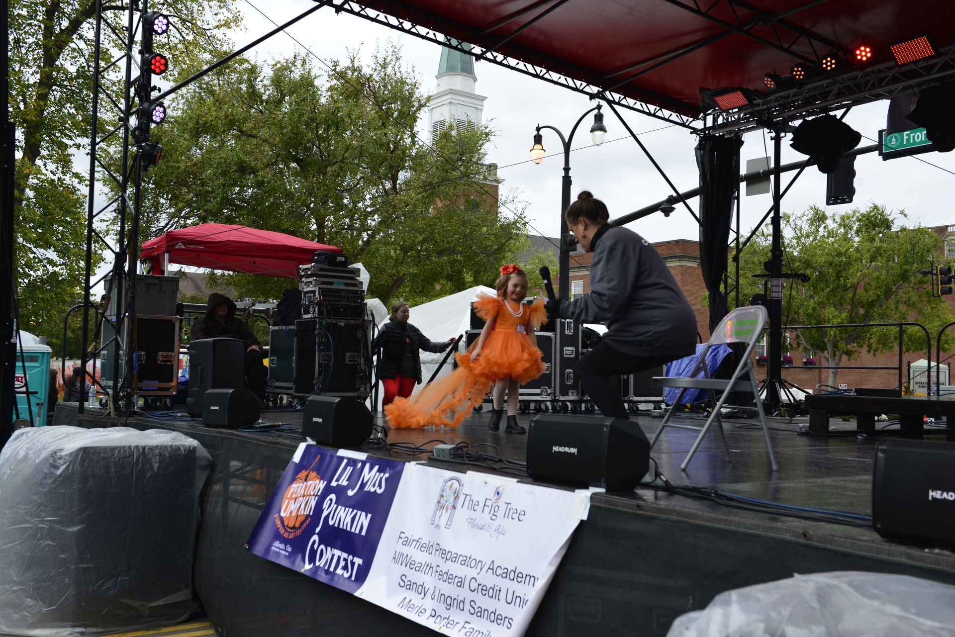 a man is sitting on a stage in front of a microphone