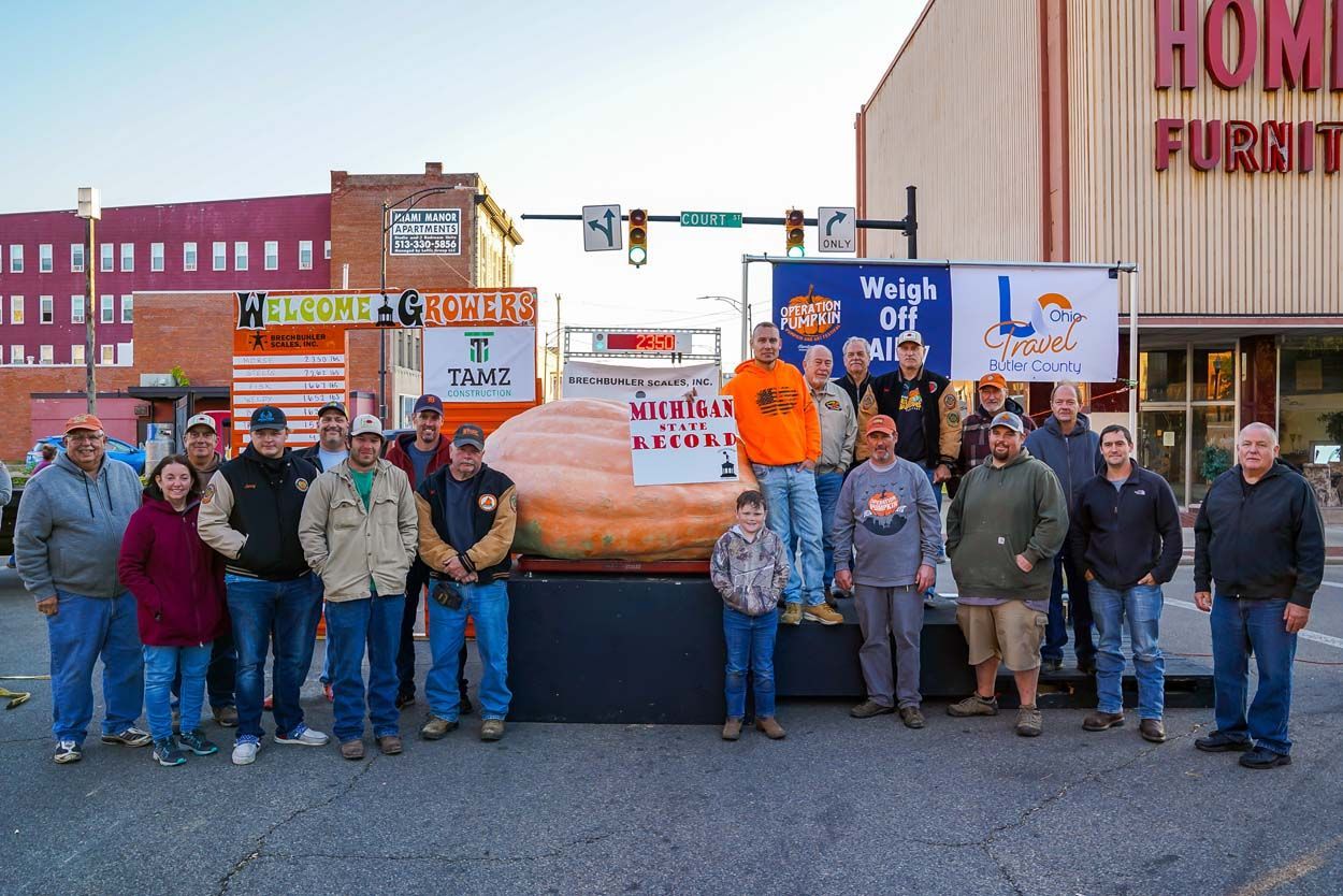 Group of people with a large pumpkin
