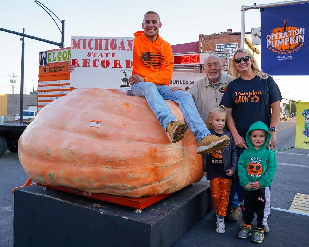 Family beside a large pumpkin