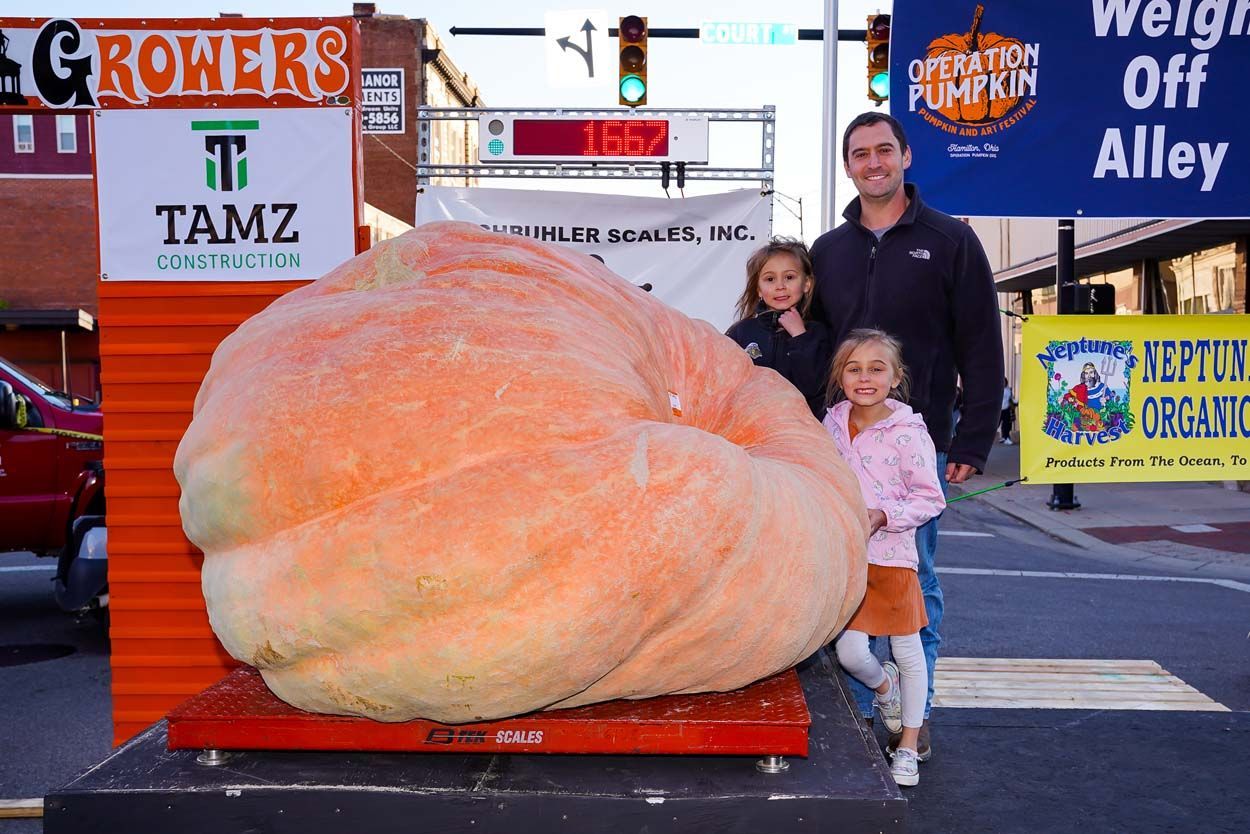 Kids beside a pumpkin