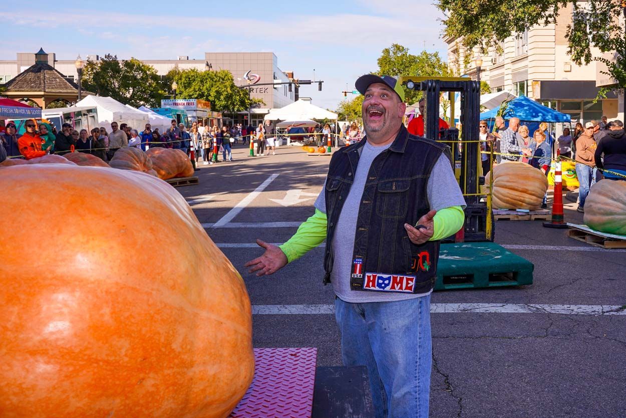 Man beside a big pumpkin