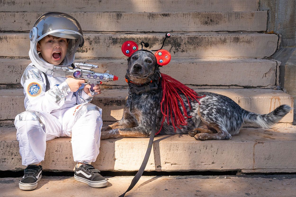 Dog and the boy in astronaut custome