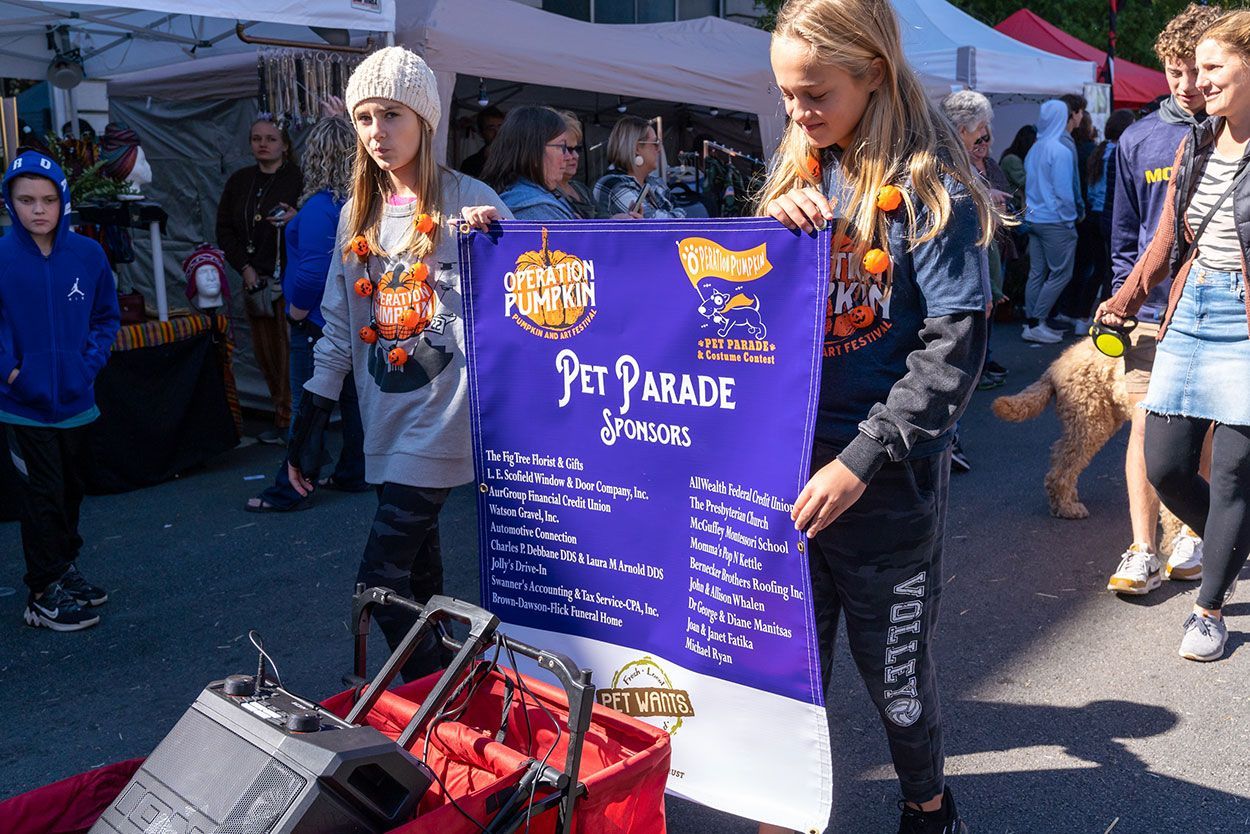 Orientation pumpkin with a pet parade banner