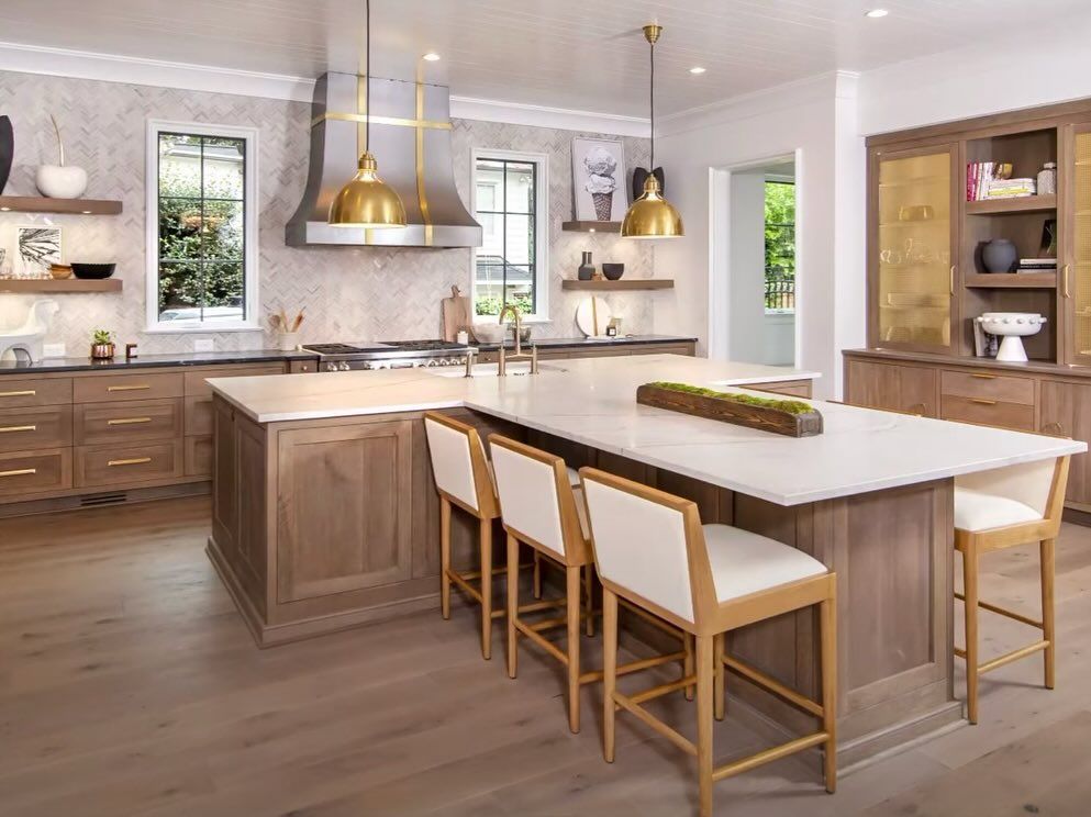 A large kitchen with a large island and stools.