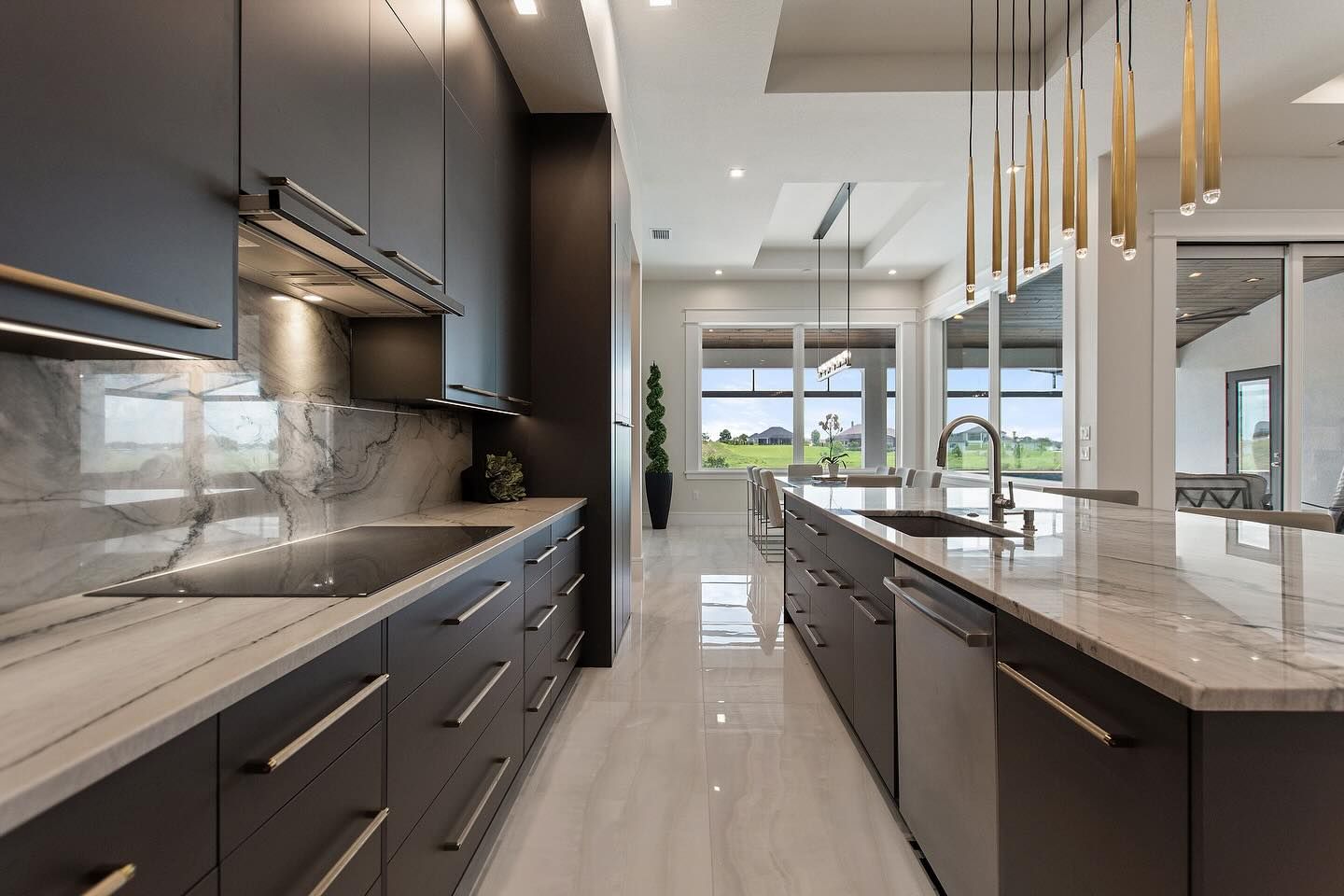 A kitchen with a lot of cabinets , a sink , and a stove.
