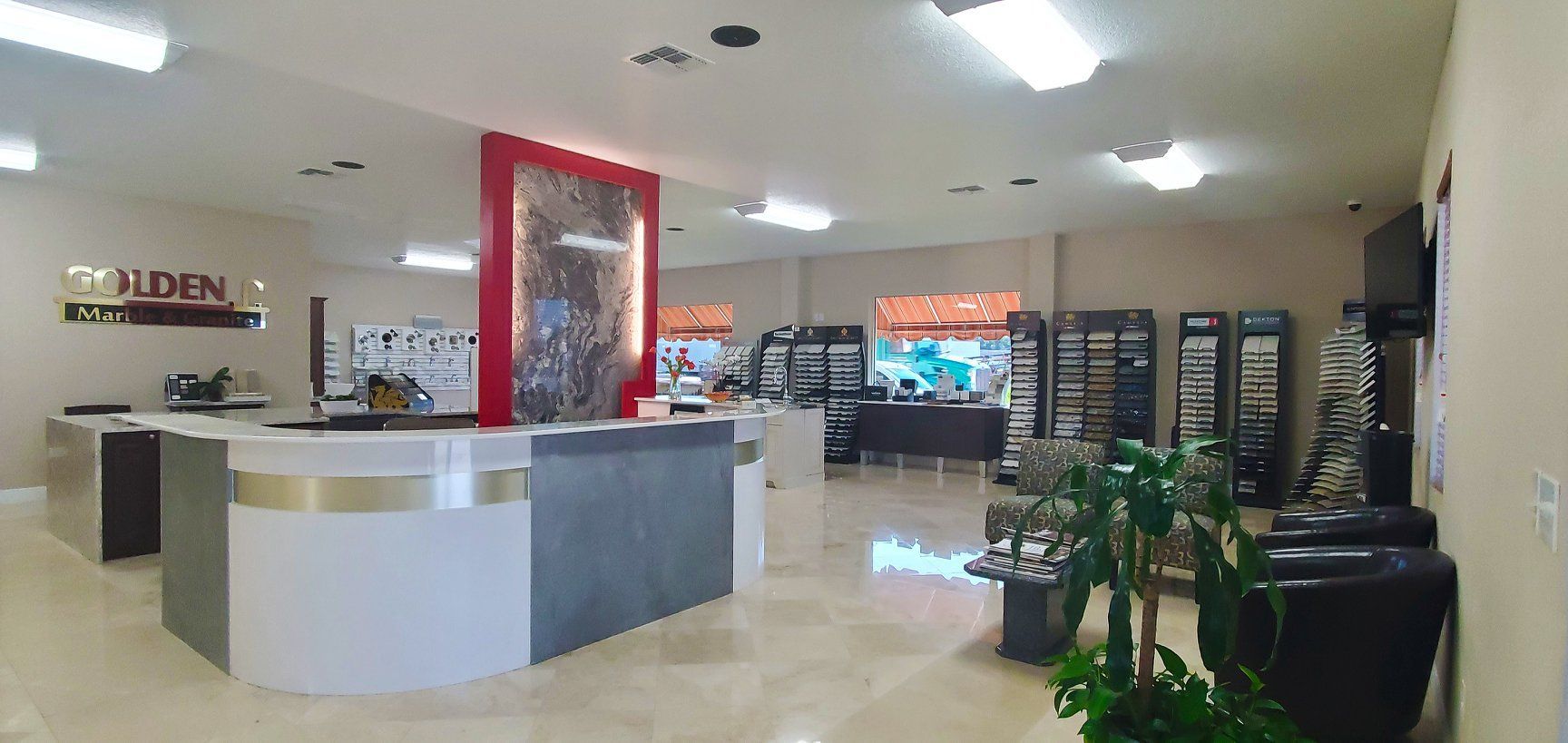 A large room with a reception desk in the middle of it.