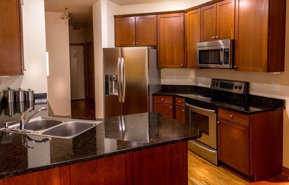 A kitchen with stainless steel appliances and granite counter tops