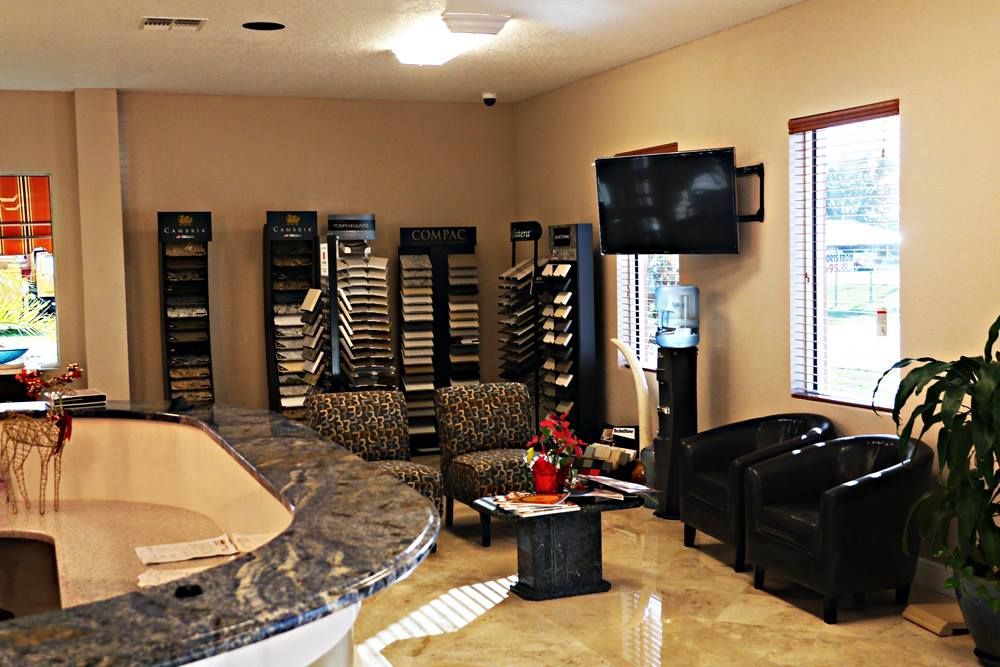 A waiting room with chairs and a tv on the wall