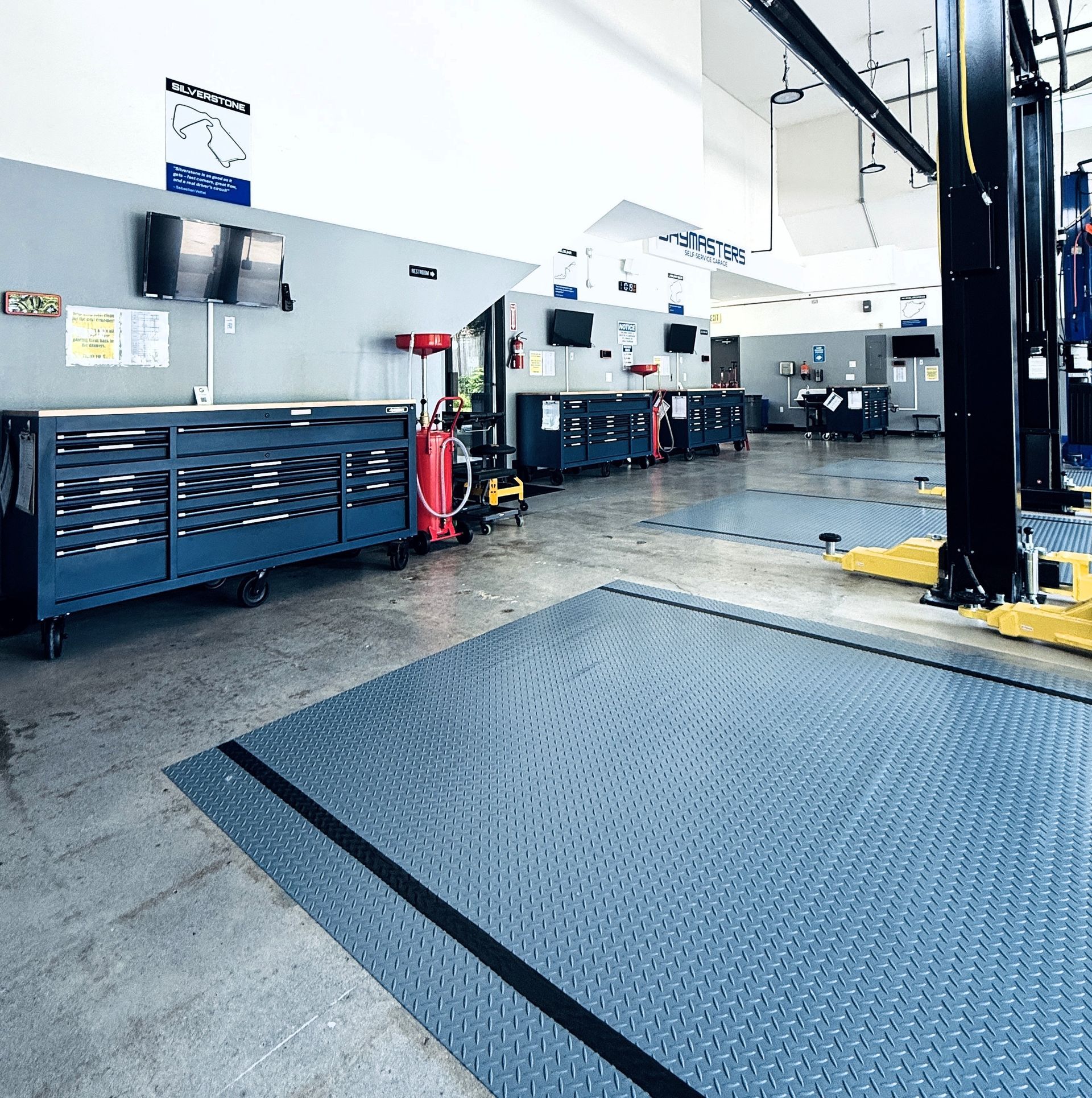 A large empty garage with a lot of tools and equipment.
