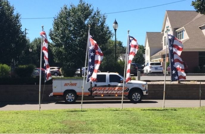 A white truck with american flags on the side of it