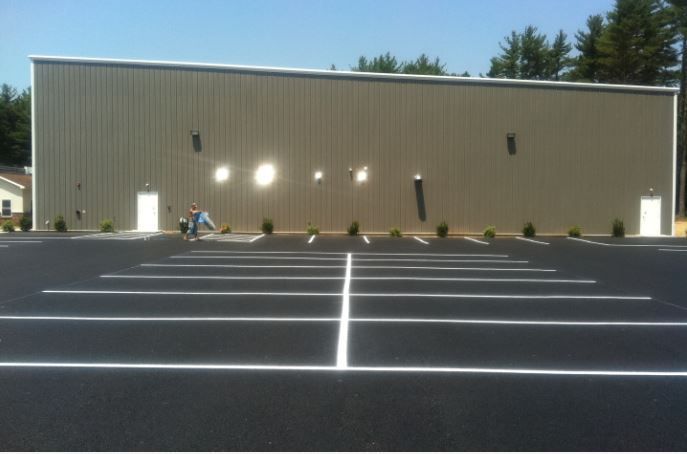 A large building with a parking lot in front of it