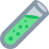 A tilted glass test tube containing a bright green liquid with small bubbles.
