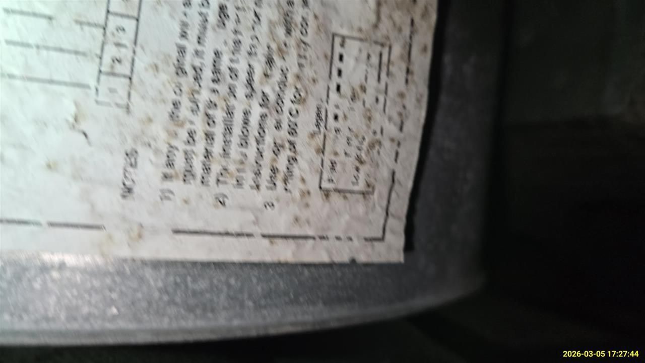 A close-up view of a printed technical schematic or installation label on a metallic surface, with partially visible text.