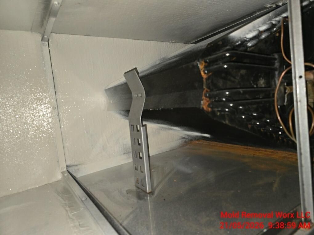 Metal duct interior with a central support brace and a black insulated section on the right.