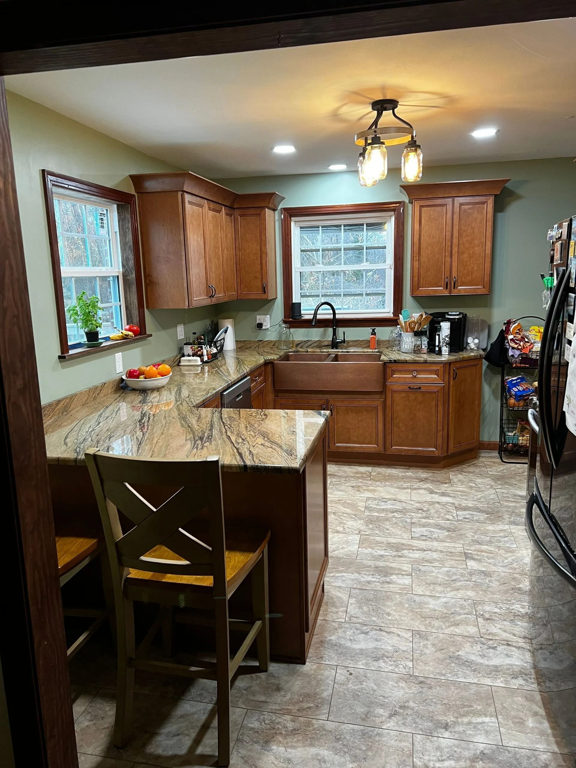 Kitchen with wooden cabinets, granite countertops, and a copper sink.