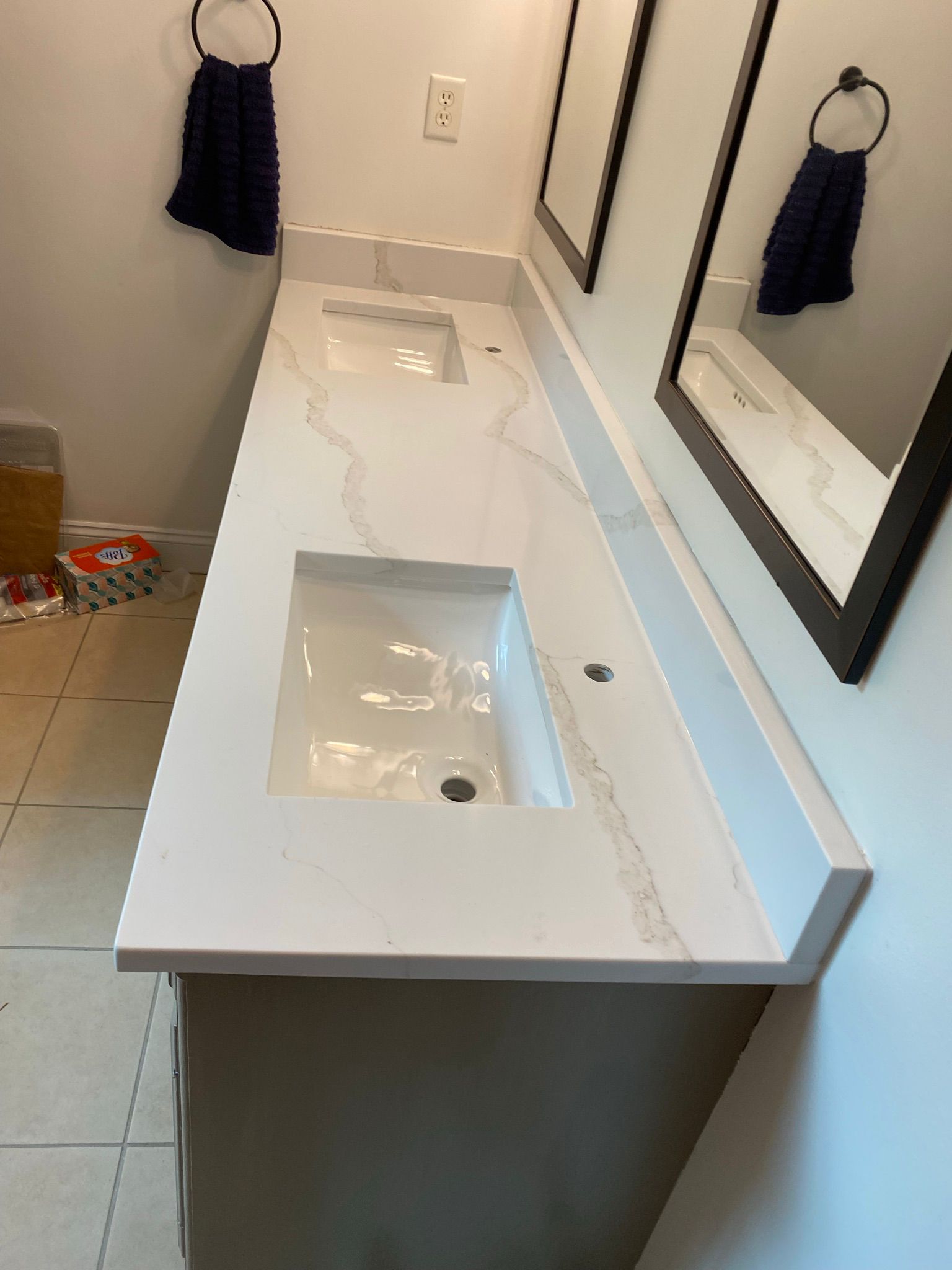 A bathroom with two sinks and two mirrors.