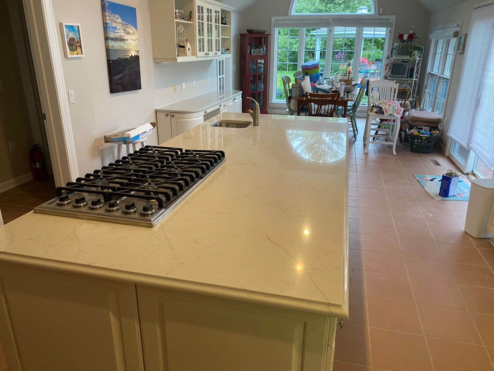 A kitchen with a stove top oven and a sink.