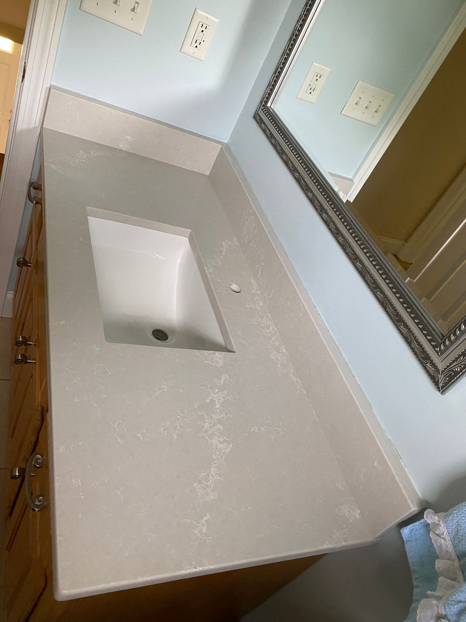 A bathroom vanity with a sink and a mirror.