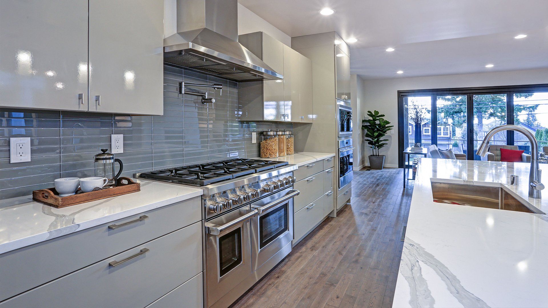 A kitchen with stainless steel appliances and white cabinets.