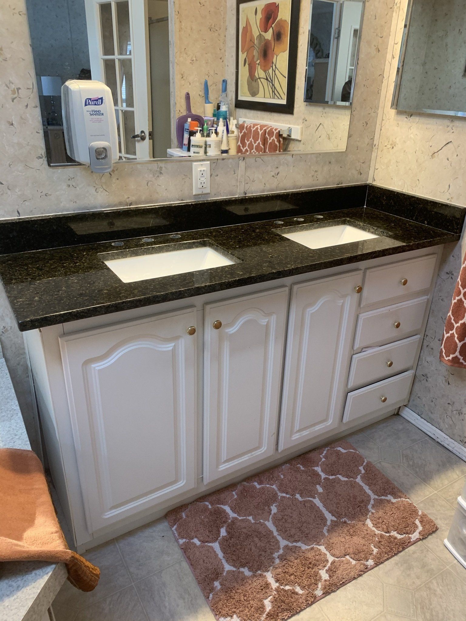A bathroom with two sinks and a mirror.