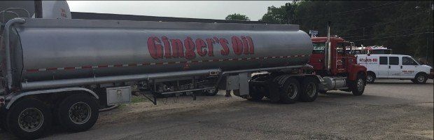 A large tanker truck is parked in a parking lot.