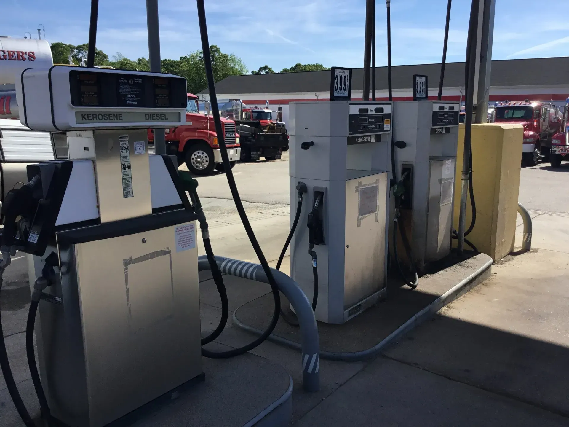 Several gas pumps are lined up at a gas station