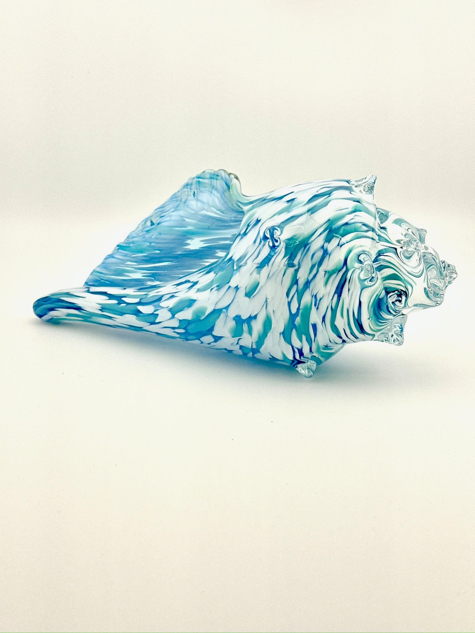 Blue-and-white striped seashell on a plain white background