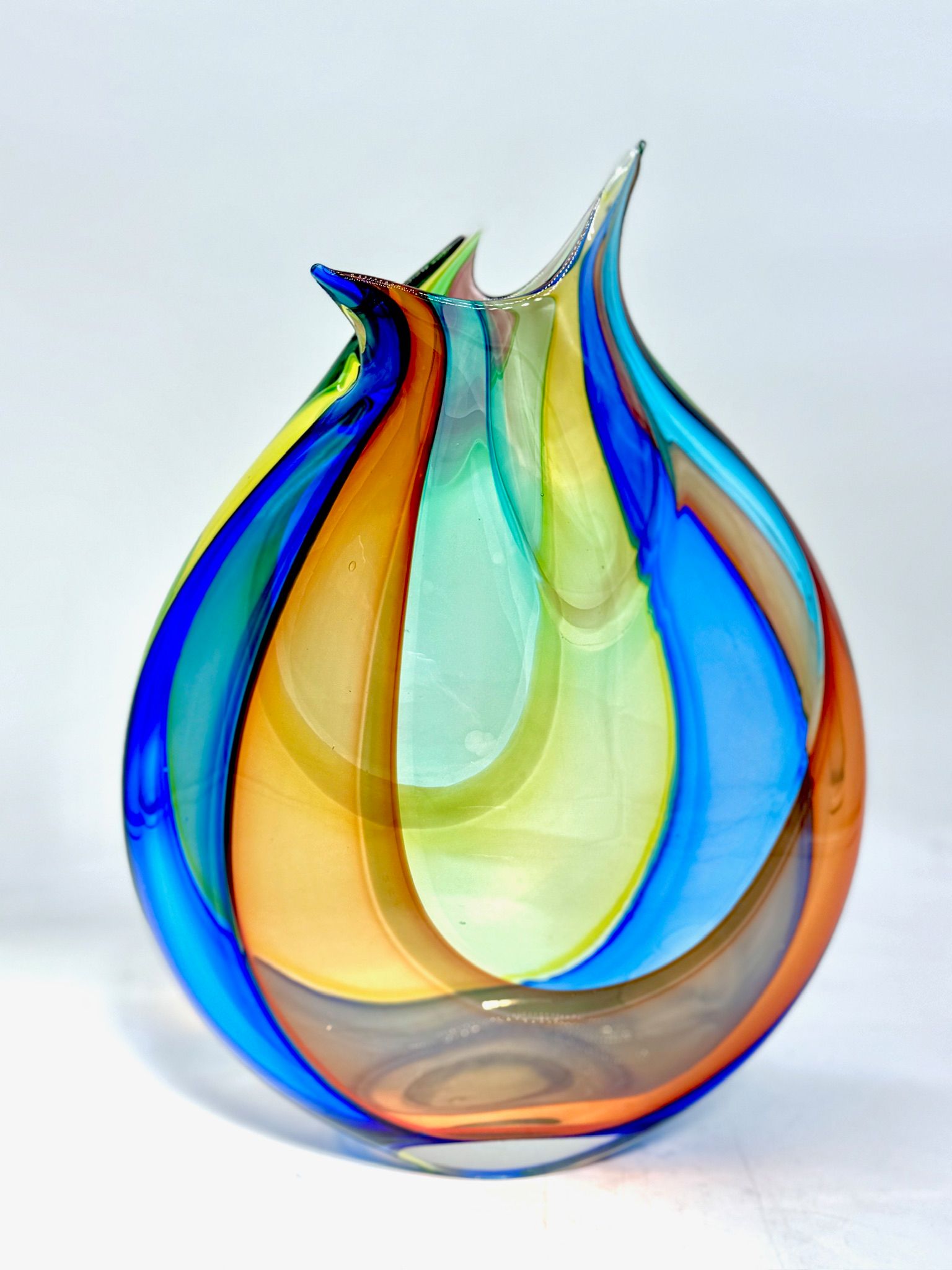 Blue and amber glass flame sculpture with swirling translucent layers