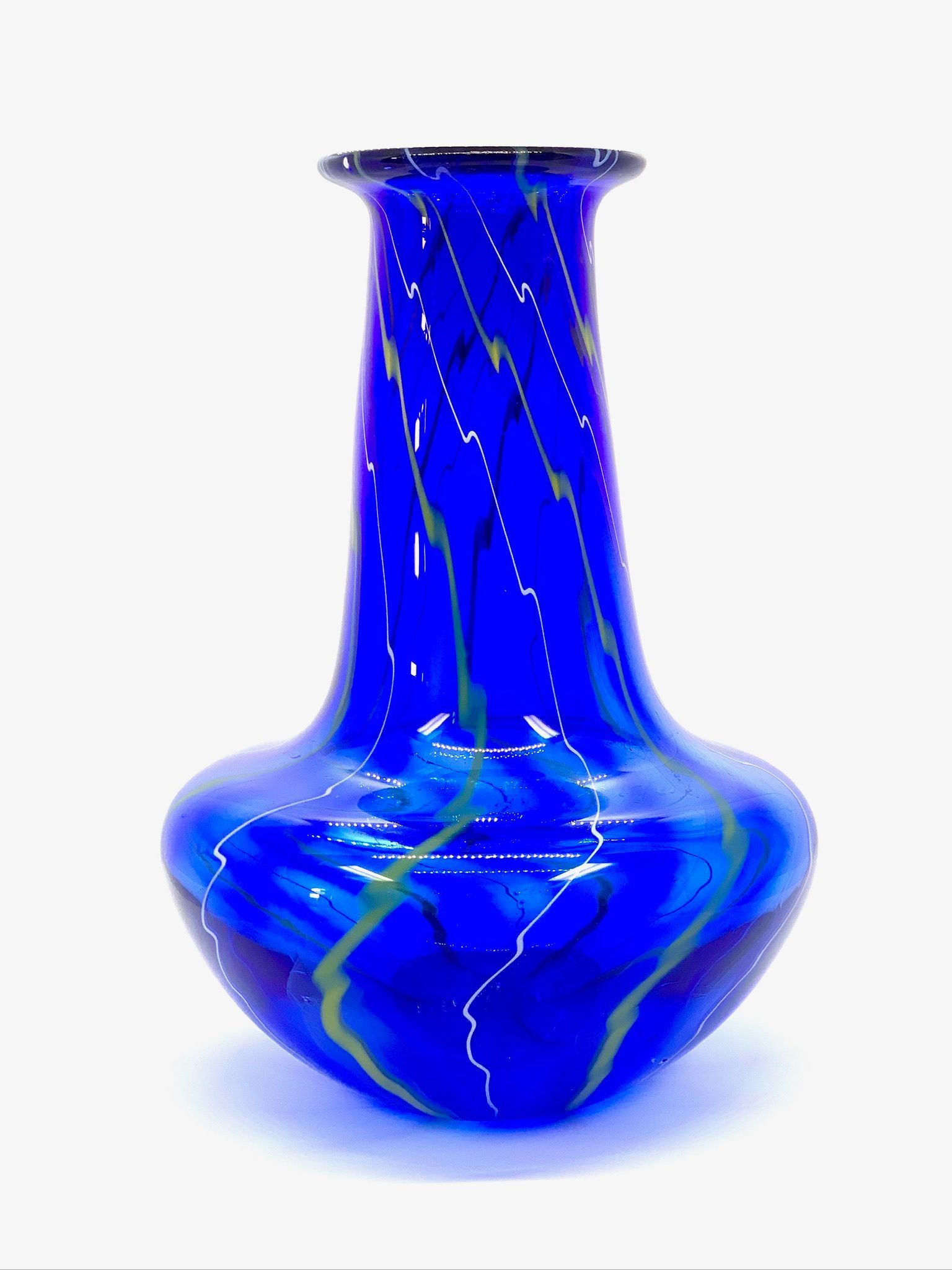 Blue glass vase with yellow swirls and a wide rounded base